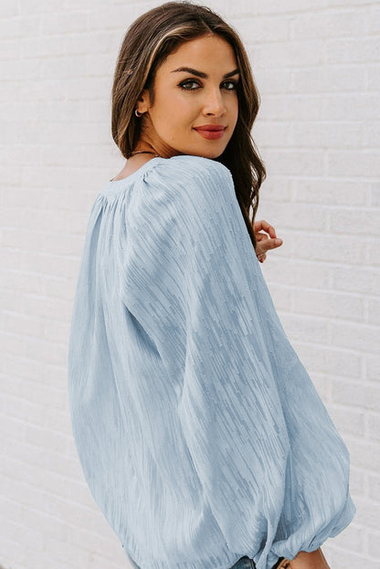 Haut uni texturé à col en V et manches lanternes 